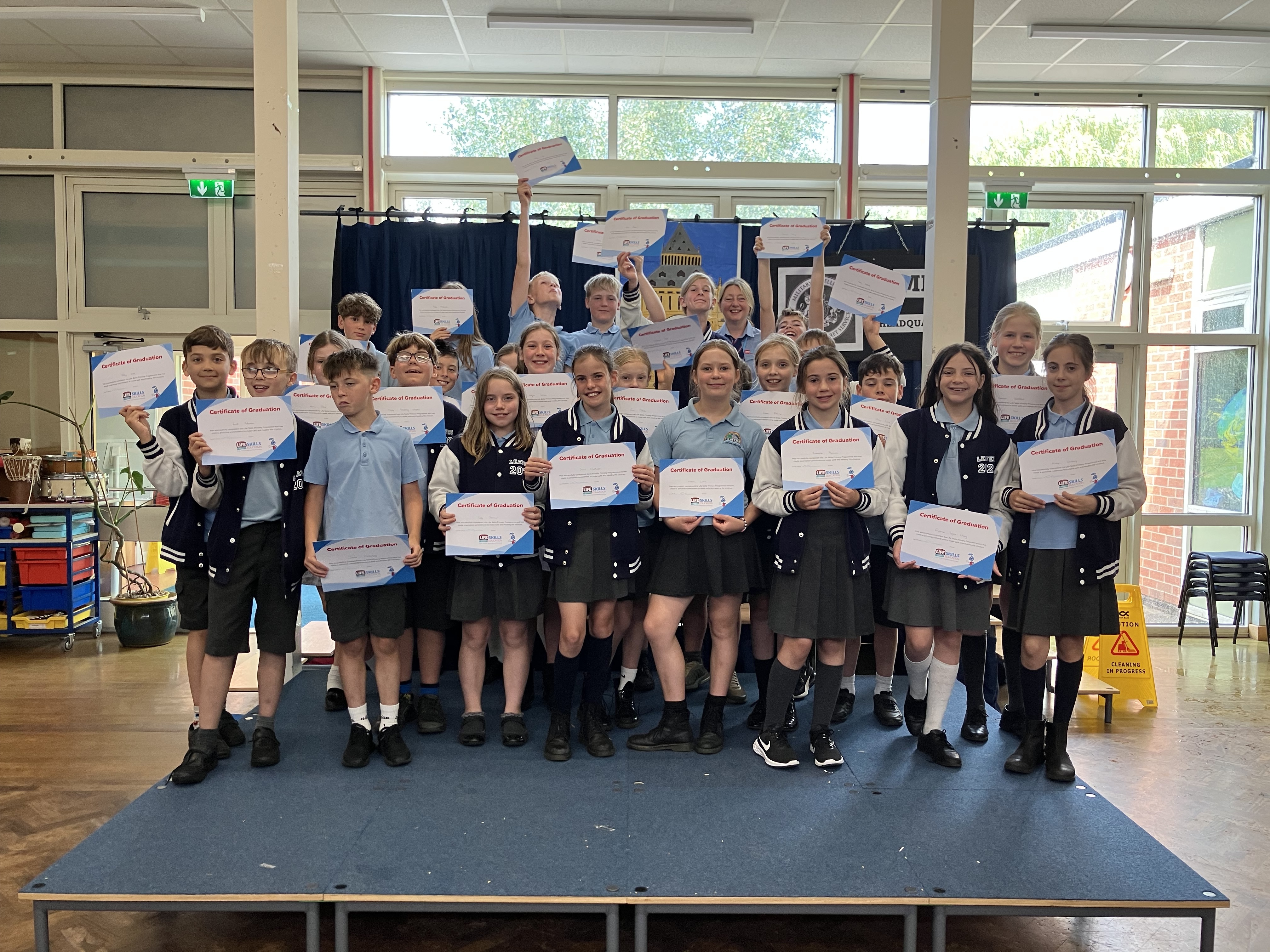 Students celebrating their Life Skills Education graduation with certificates